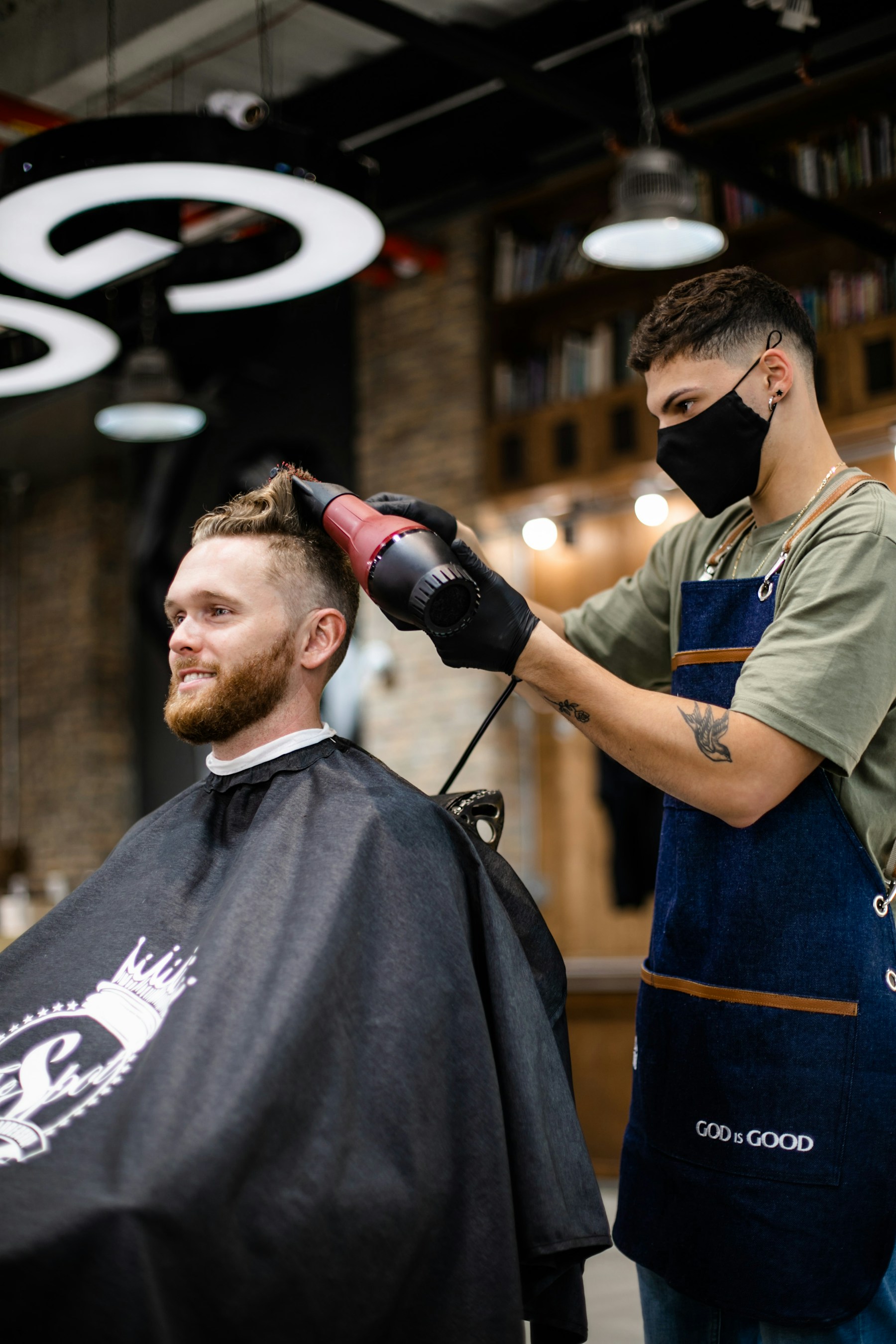 Barber finishing a client’s haircut
